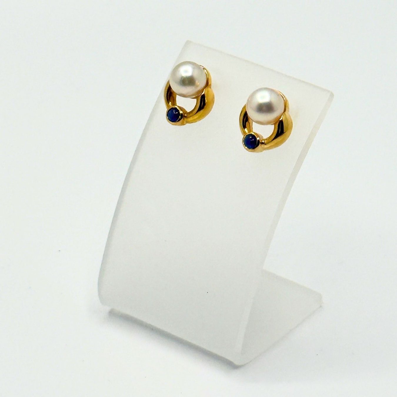 Earrings & pearls from Henley County Jewellers, photographed on neutral white